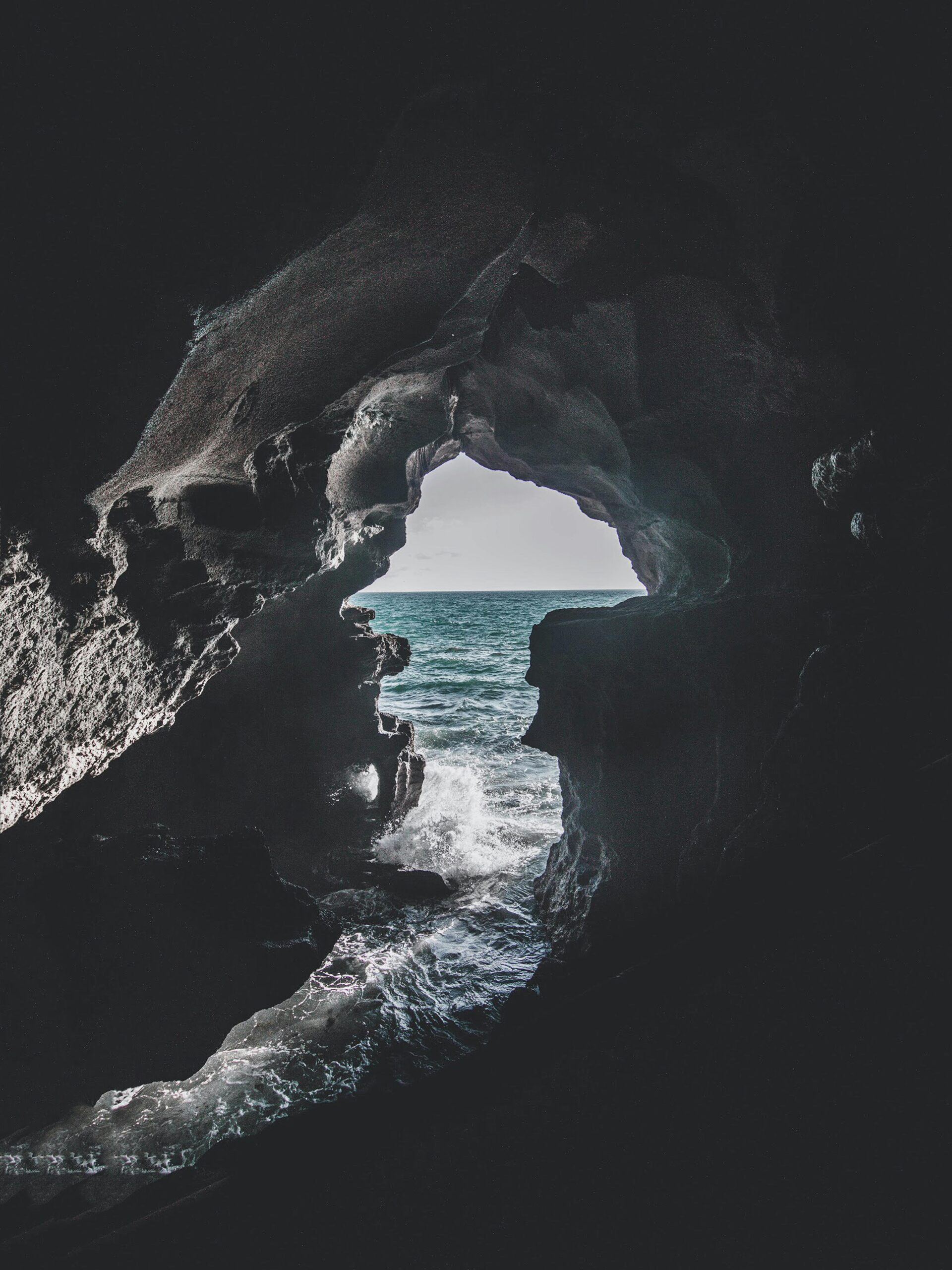 Stunning ocean view from a cave in Morocco, showcasing the play of light and shadow.